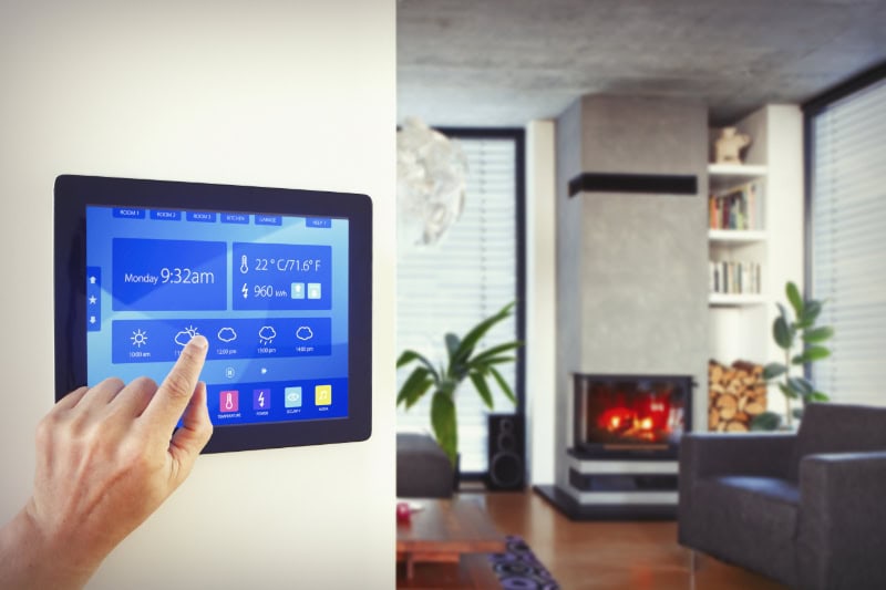 Homeowner adjusting temperatures on his new zone control system controller.